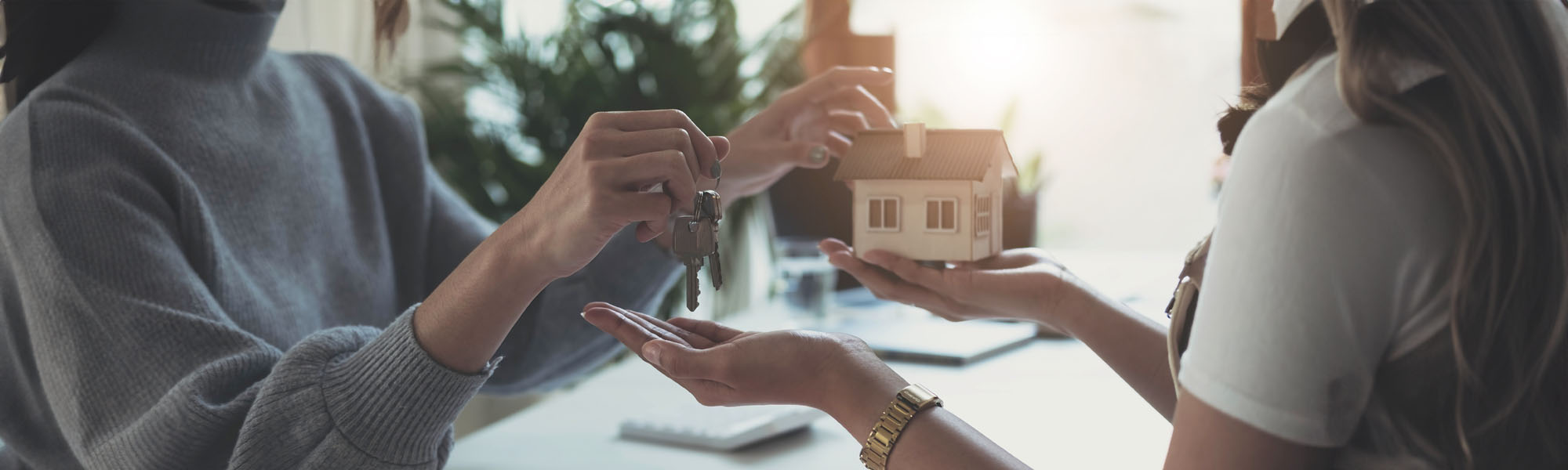 estate agent giving house keys to woman