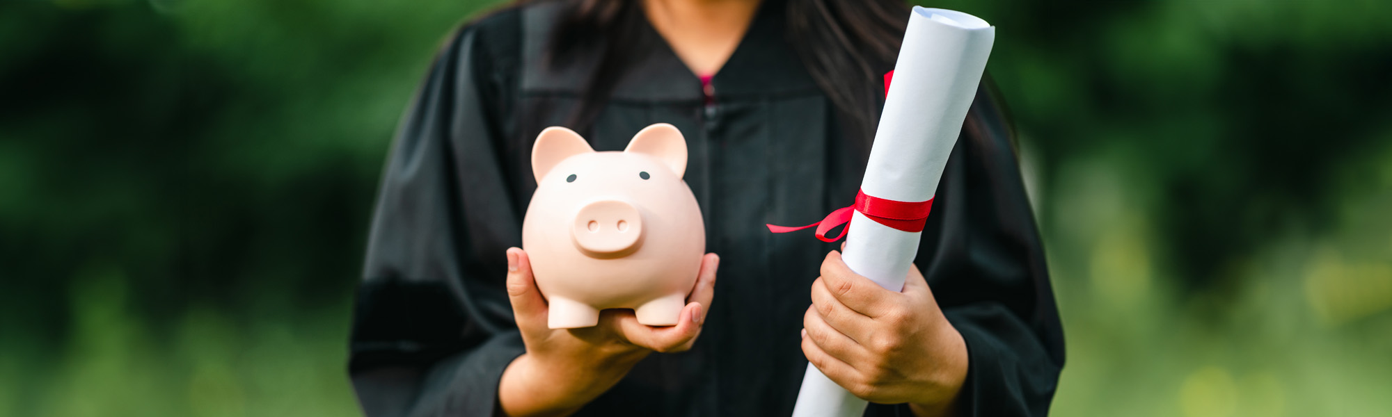 graduates holding piggy banks saving concept