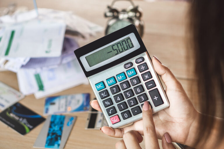 woman hand holding calculator showing number budget deficit
